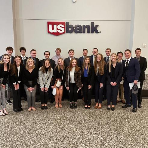 A group photo in front of the US Bank logo.