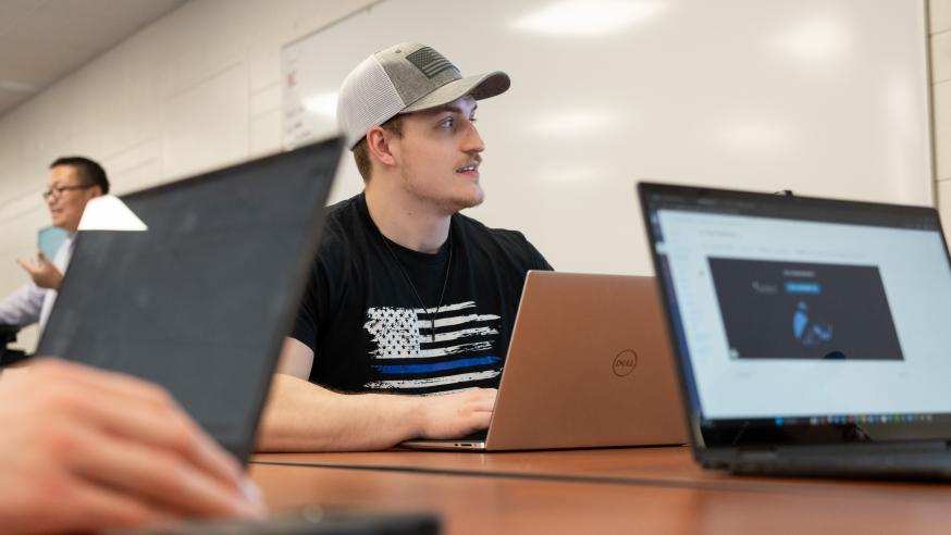 male student in accounting classroom