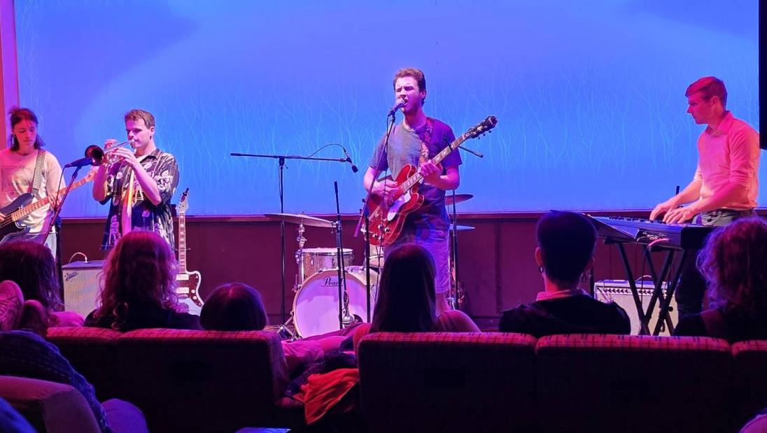 Four band members performing in The Cabin