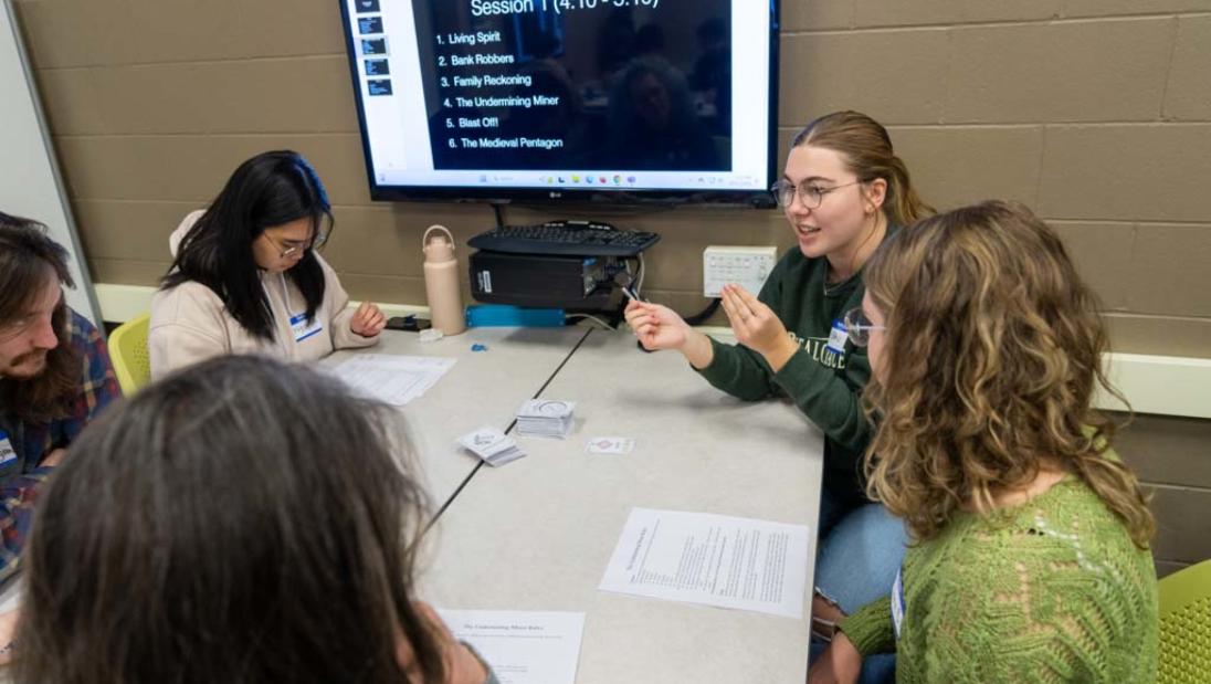 honors students sit around table
