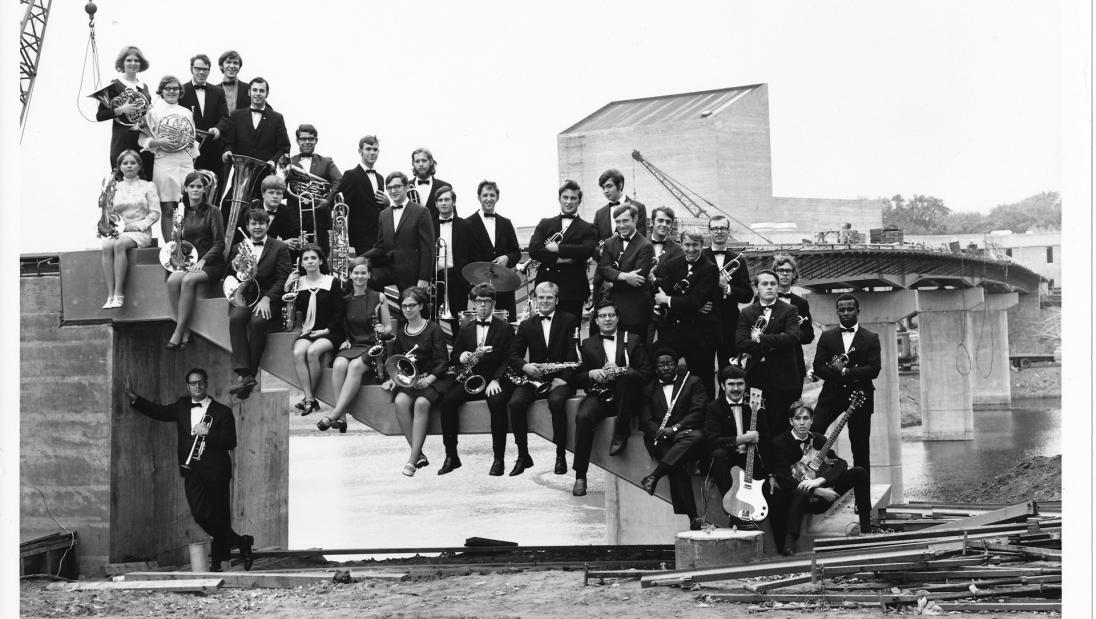 music group posing on unfinished footbridge UWEC