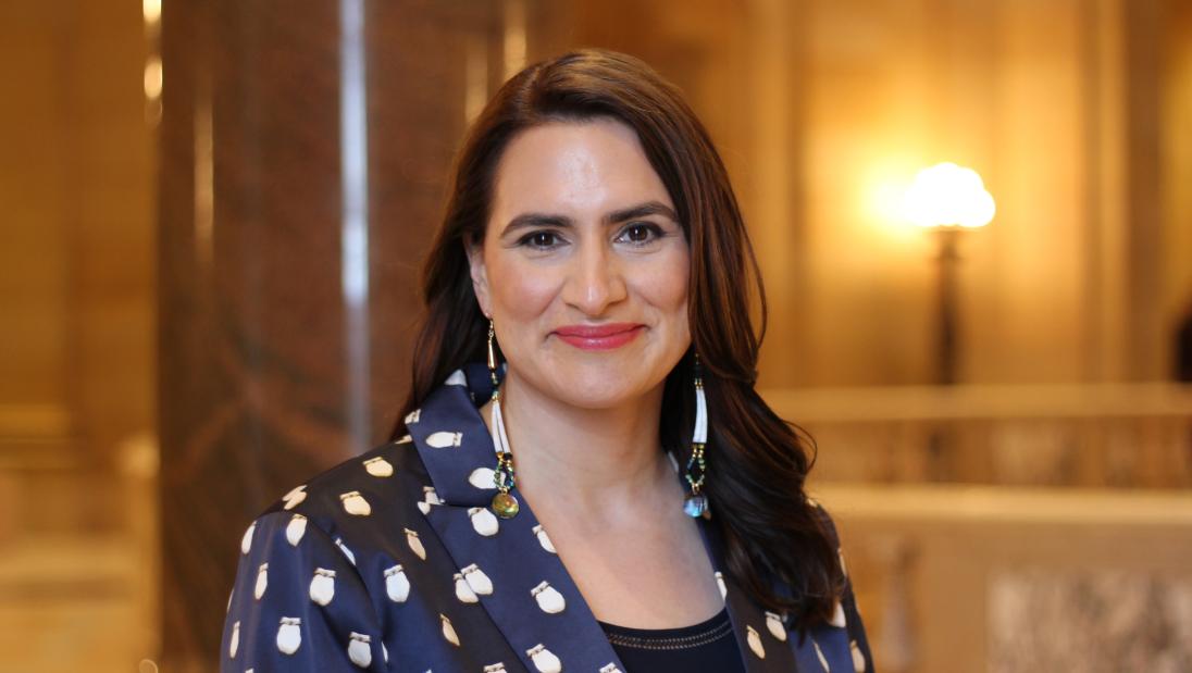 A woman smiles at the camera.