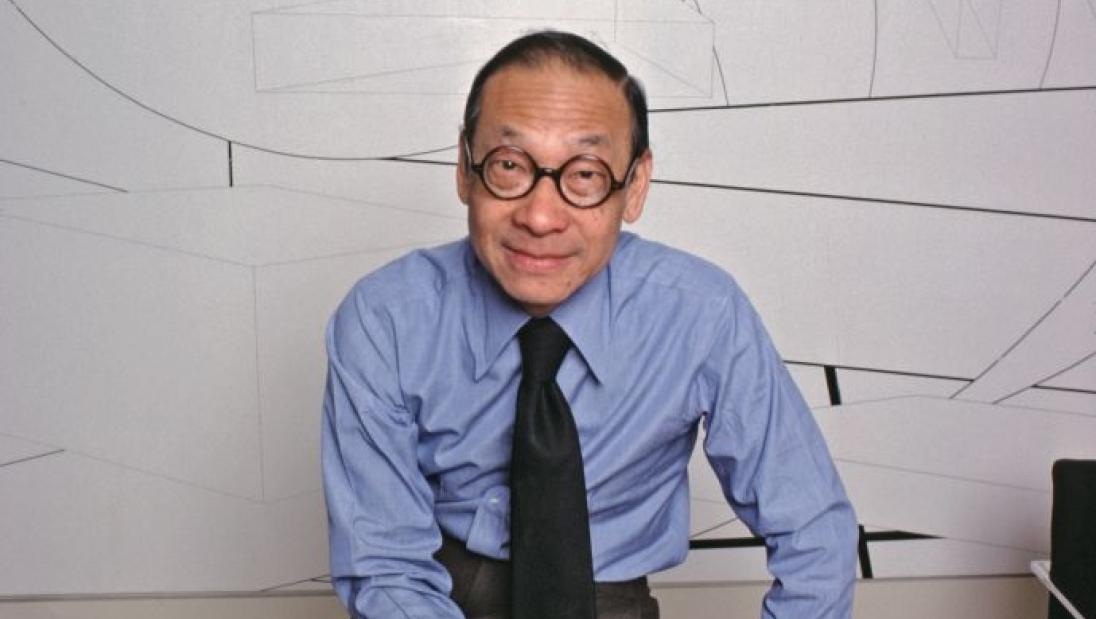 A man smiles at the camera while sitting down.