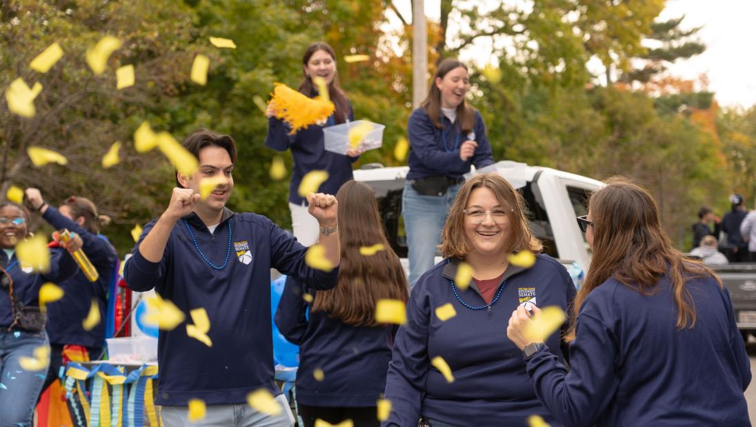 people in parade with confetti