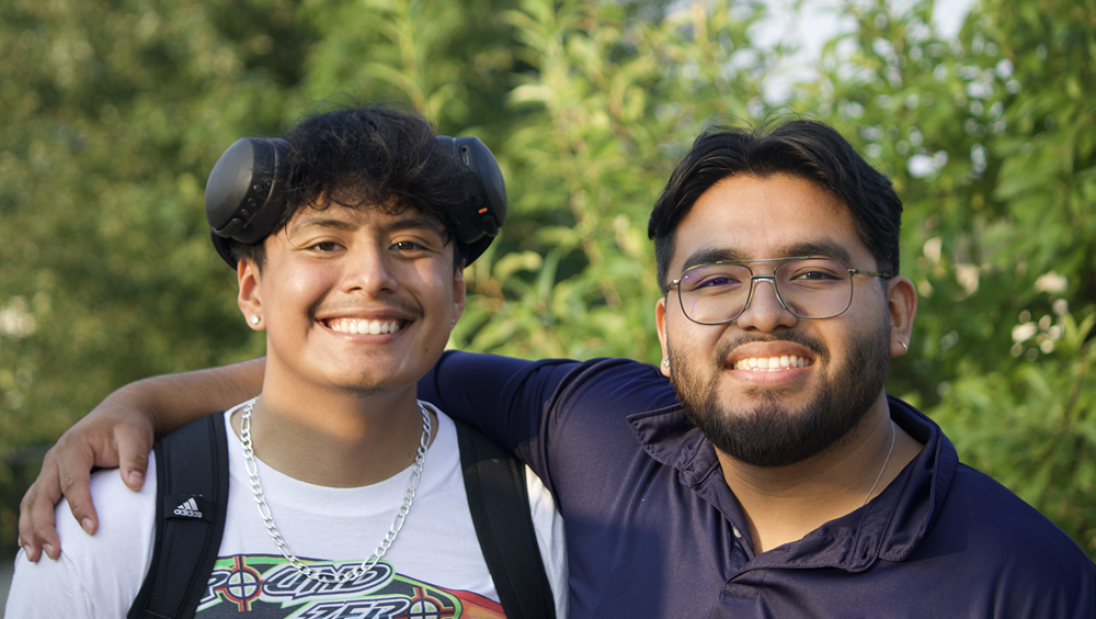 Two Multicultural Student Services students posing for a photo and smiling