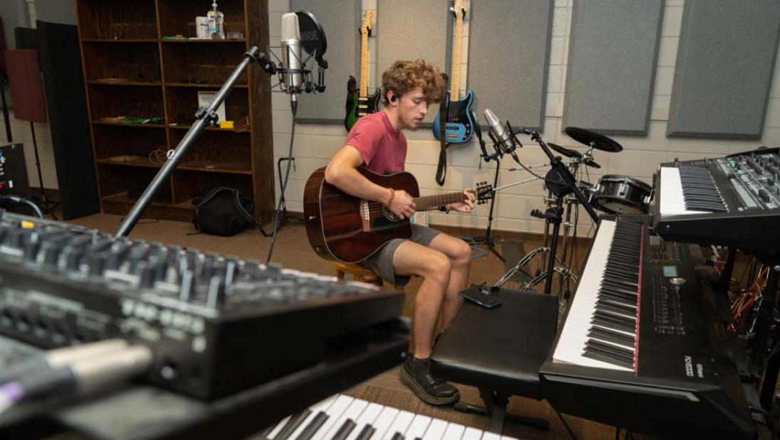 Guitarist recording in recording studio