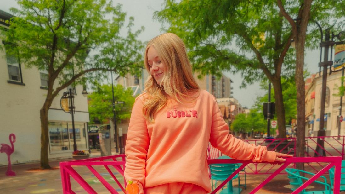 Marketing major, Jordan Rye, standing outside with Bubbl'R attire for internship at Bubbl'R