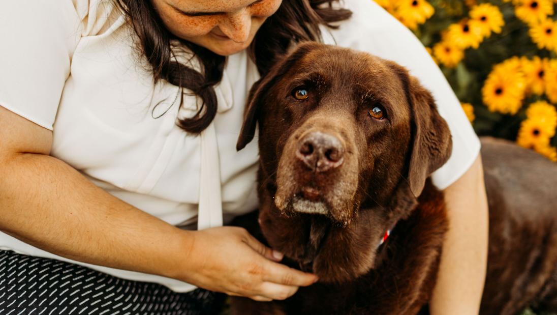 Megan Eilers snuggles up to her therapy dog, Koda