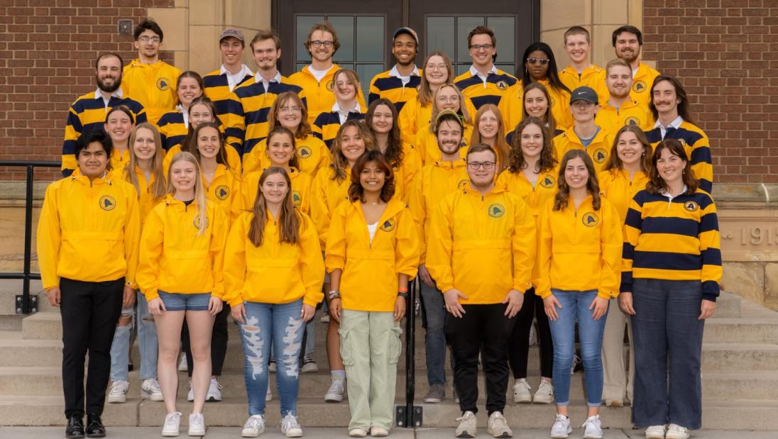 Campus Ambassadors pose for picture in their blue and gold shirts