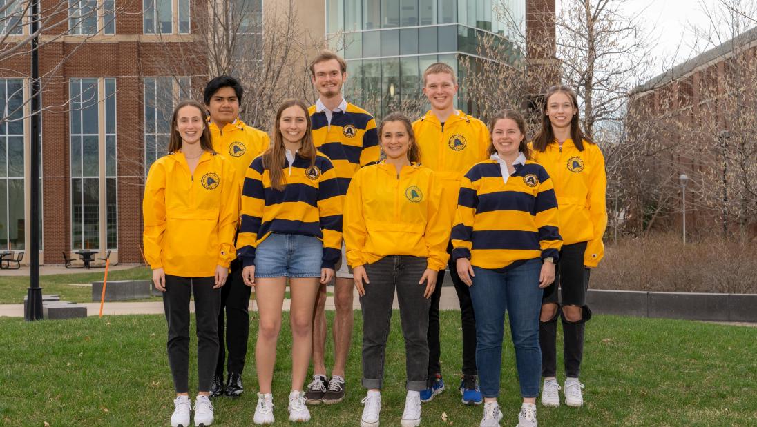 Campus Ambassadors pose for picture in their blue and gold shirts