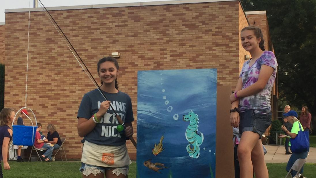 Childhood Hannah Schindler poses with friend at a community art event