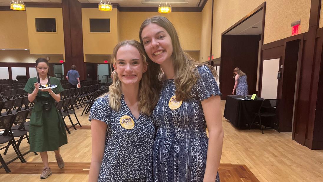 Hannah Schindler (right) poses with fellow honors student Maddie Sasse (left)