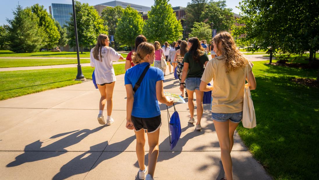 students walking and talking on campus