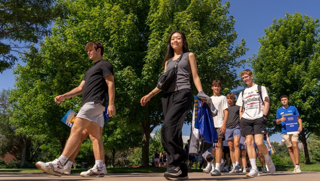 students walking on campus on a sunny day