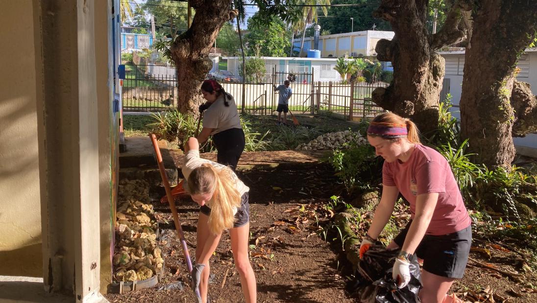 Students doing yard work at a community center in Puerto Rico