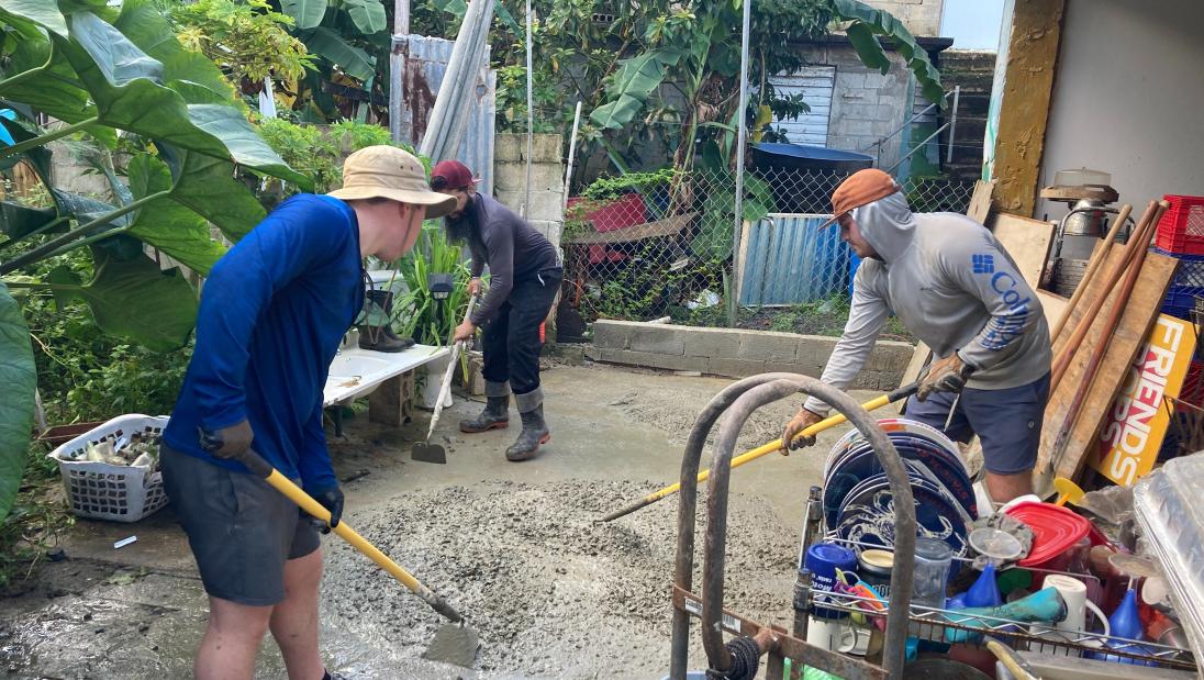 Students mixing concrete on a housing project in Puerto Rico