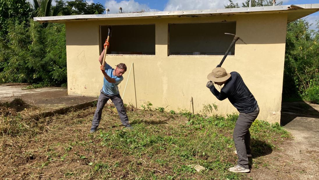 Two students doing yard work in Puerto Rico