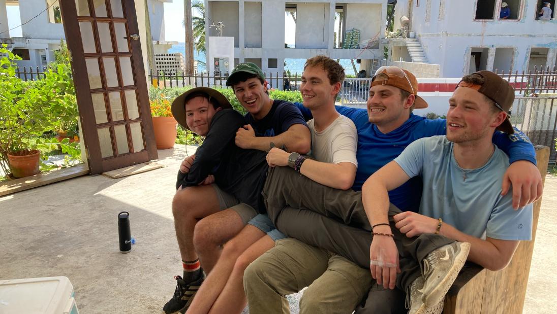 One student laying across the laps of other students on a break in Puerto Rico