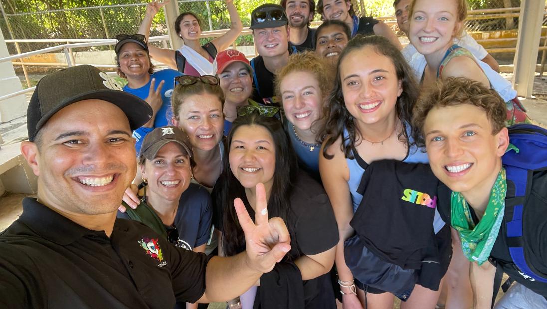 Group selfie with several students and a community member they volunteered with