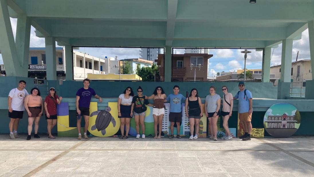 Group photo in front of the Luquillo town sign in Puerto Rico
