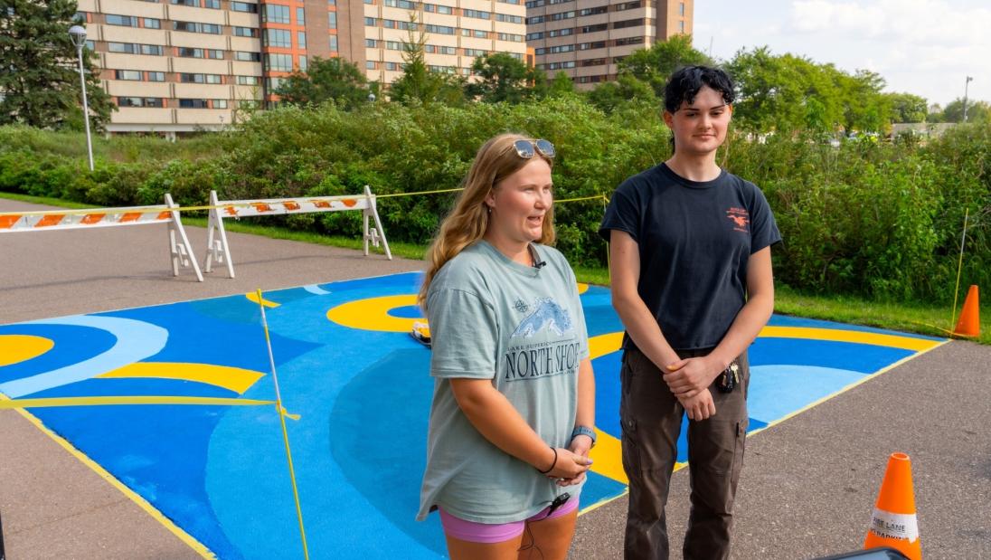 Christine Myhre Ada Mechelke discuss SSD TRIO Project AIM mural painting