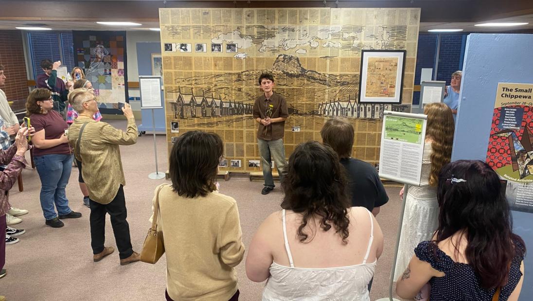 Kai Hirata speaks to guests at the opening reception of "The Small and the Mighty: Chippewa Valley" exhibit inside McIntyre Library on Oct. 7.