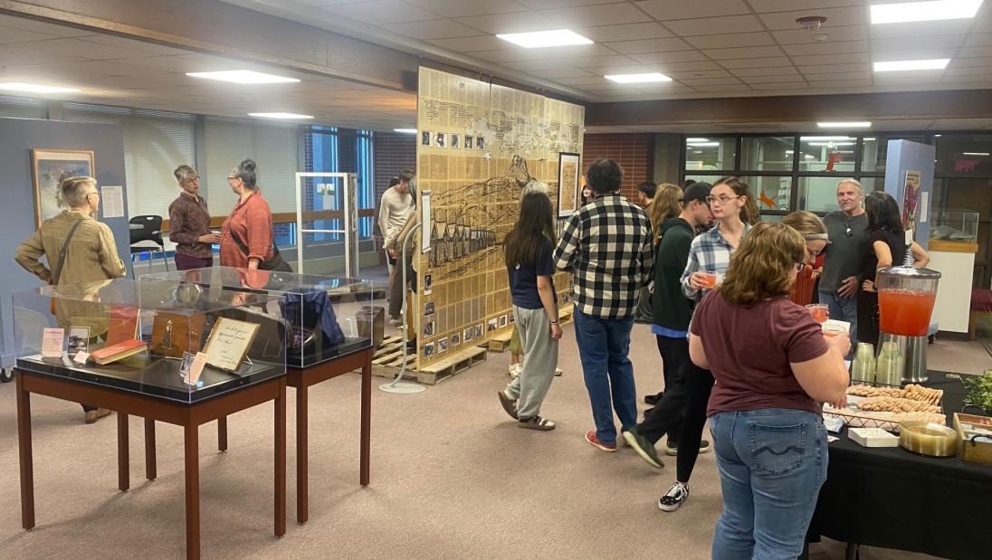 Guests explore "The Small and the Mighty: Chippewa Valley" exhibit during its opening reception