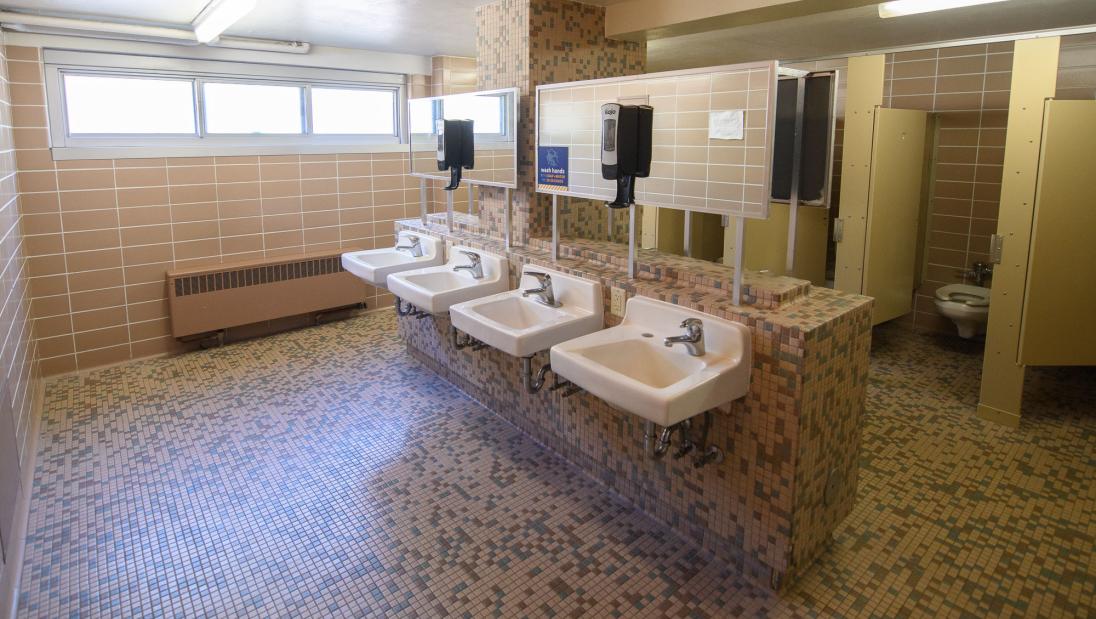 Horan Hall bathroom with sinks and toilet stalls.