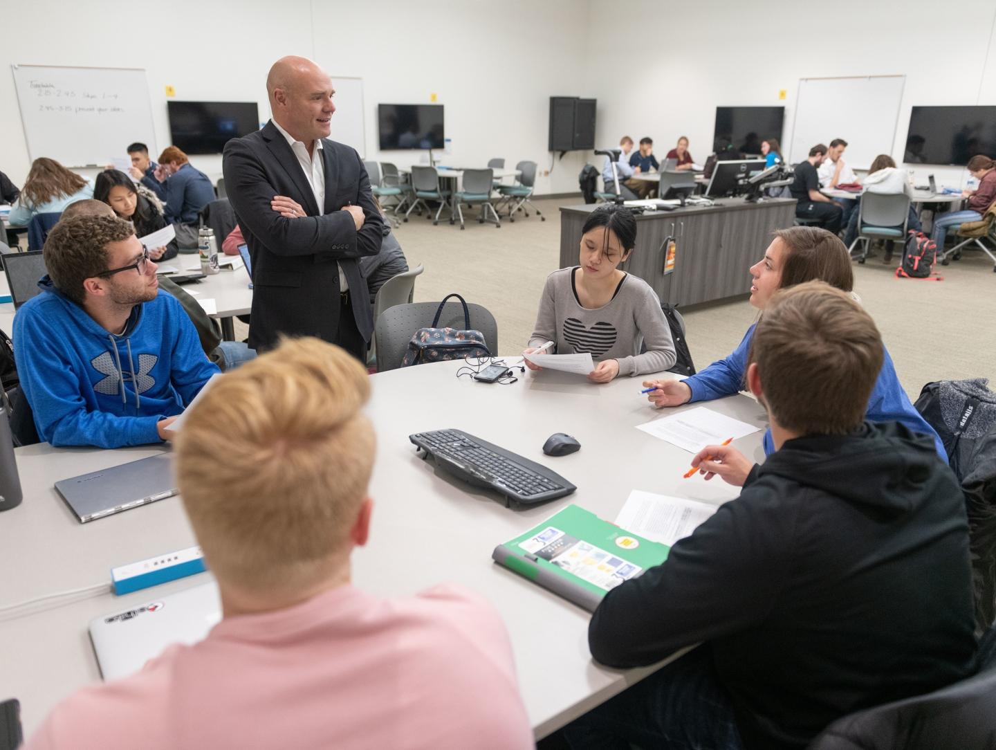 Supply chain classroom students at tables 