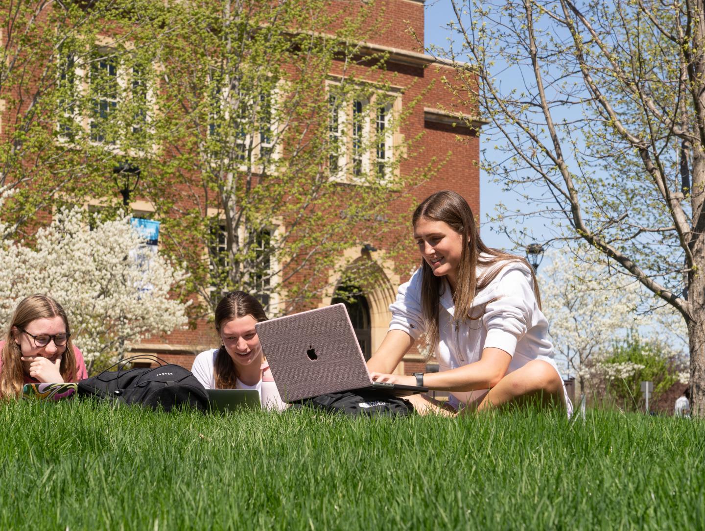 Students study on the campus mall on a Spring day.