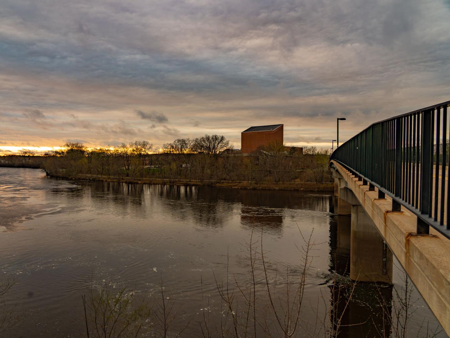 The Chippewa River at sunset with Haas Fine Arts Center in the background