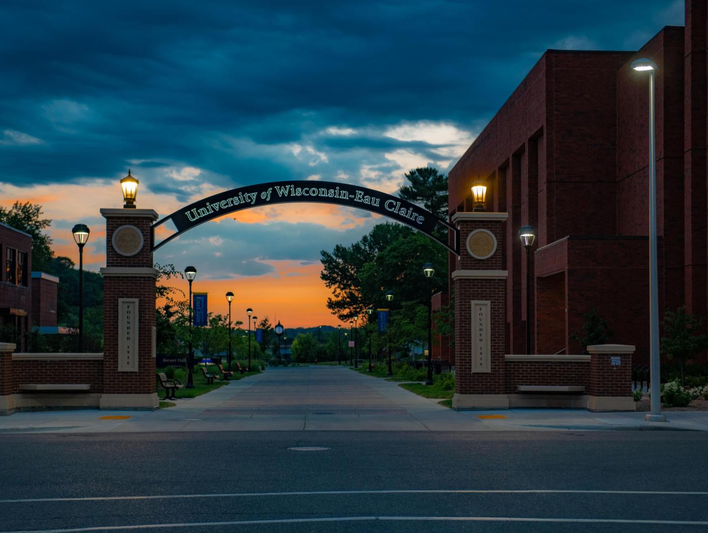 An evening picture of the UW-Eau Claire entrance gate with arch.