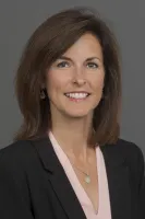 Jeanette Olsen smiling at camera for headshot photo.