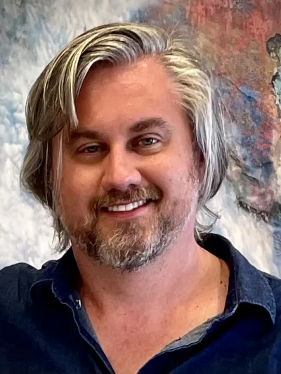 An headshot of Adam Kunz