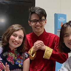 three students in Asian costume