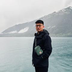 Marcus McEllistrem poses for a photo in front of a body of water