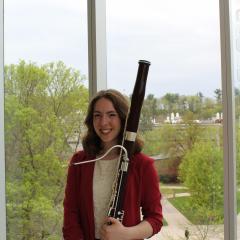 Female bassoon player with her instrument
