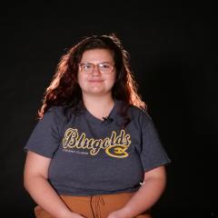 Sarah smiles at camera.