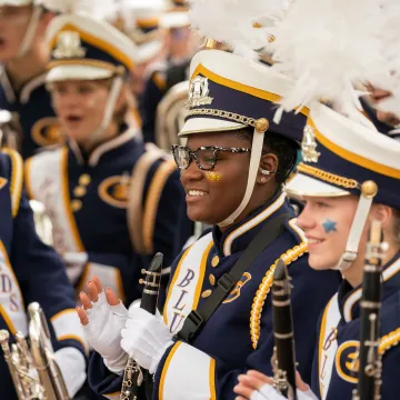 Students smiling in their Blugold Marching Band attire 