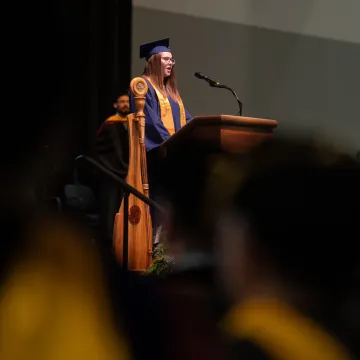 student commencement speaker on stage 