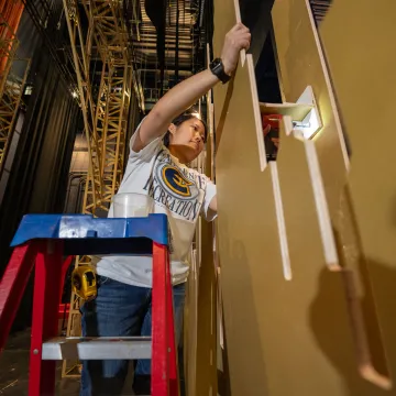 student painting stage set 