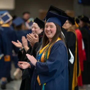 Student Body President, Sam Consiglio, cheers on students at commencement