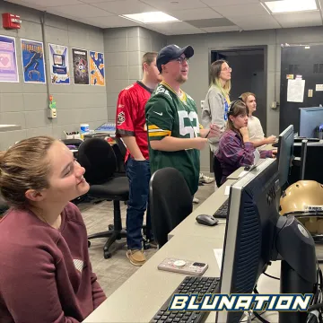 The BluNation team watching a recording of a segment.