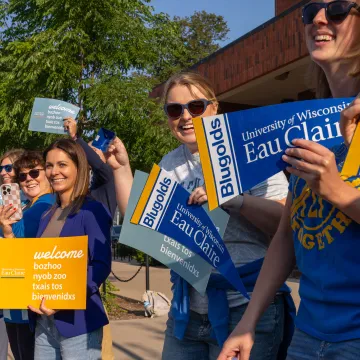 UWEC faculty and staff cheer on students as they walk across campus on their first day of school.
