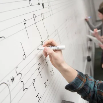 Music theory student writing four-part harmony