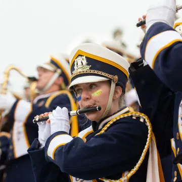 A closeup of a student in the BMB playing the flute.