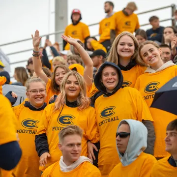 Students wear their new Blugold gear at a Football game.