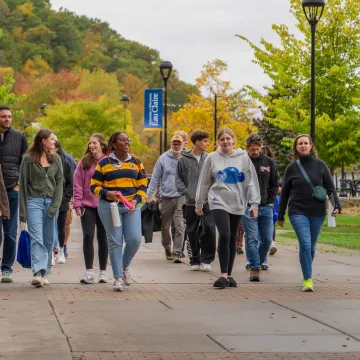 Prospective Blugolds tour campus while fall beauty emerges in the background.