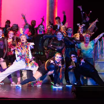 Music theatre performance group on stage