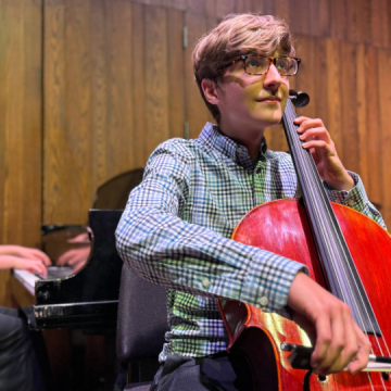 String Academy cellist student performing in Phillips Recital Hall